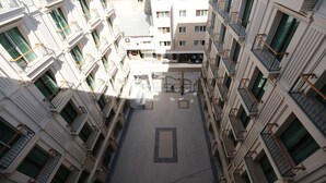 A multi-story hotel with a central courtyard, balconies, and a uniform architectural style. - Royal Palas Hotel (Van)