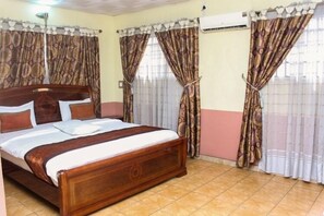 Deluxe Room | Desk, laptop workspace, blackout drapes, iron/ironing board - Everyday Check Inn Limited (Port Harcourt)