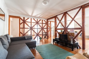 Relax in this inviting living space with a large sofa, coffee table, and cozy rug.
