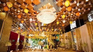 A decorated indoor space with a 'Happy Birthday' banner, patterned ceiling, and various table settings. - Tuan Vu Hotel (Buon Ma Thuot)