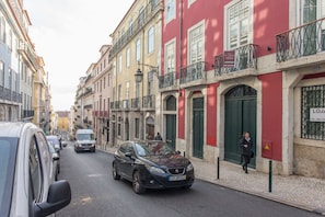A street with parked cars and buildings.