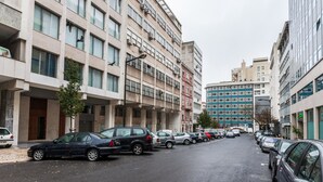 A multi-story parking garage with cars parked on both sides.