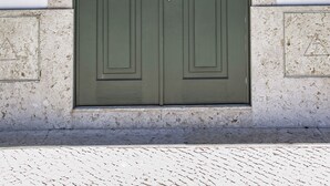 A double door with a number "72" above it, set in a textured wall. - FLH Restauradores Luxus Flat (Lisbon)