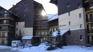 Un hôtel à plusieurs étages, doté de balcons et d’une façade en pierre.