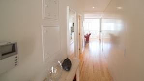 A modern kitchen with white cabinets, a wooden countertop, and a microwave. - FLH Príncipe Real with View (Lisbon)