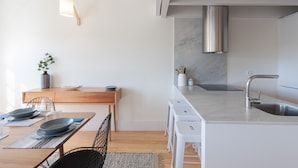 A modern kitchen with white countertops, a stainless steel sink, and a marble backsplash. - FLH Douro View Luxury Duplex (Oporto)