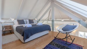 A bedroom with a bed, a chair, a desk, and a window. - FLH Douro View Luxury Duplex (Oporto)