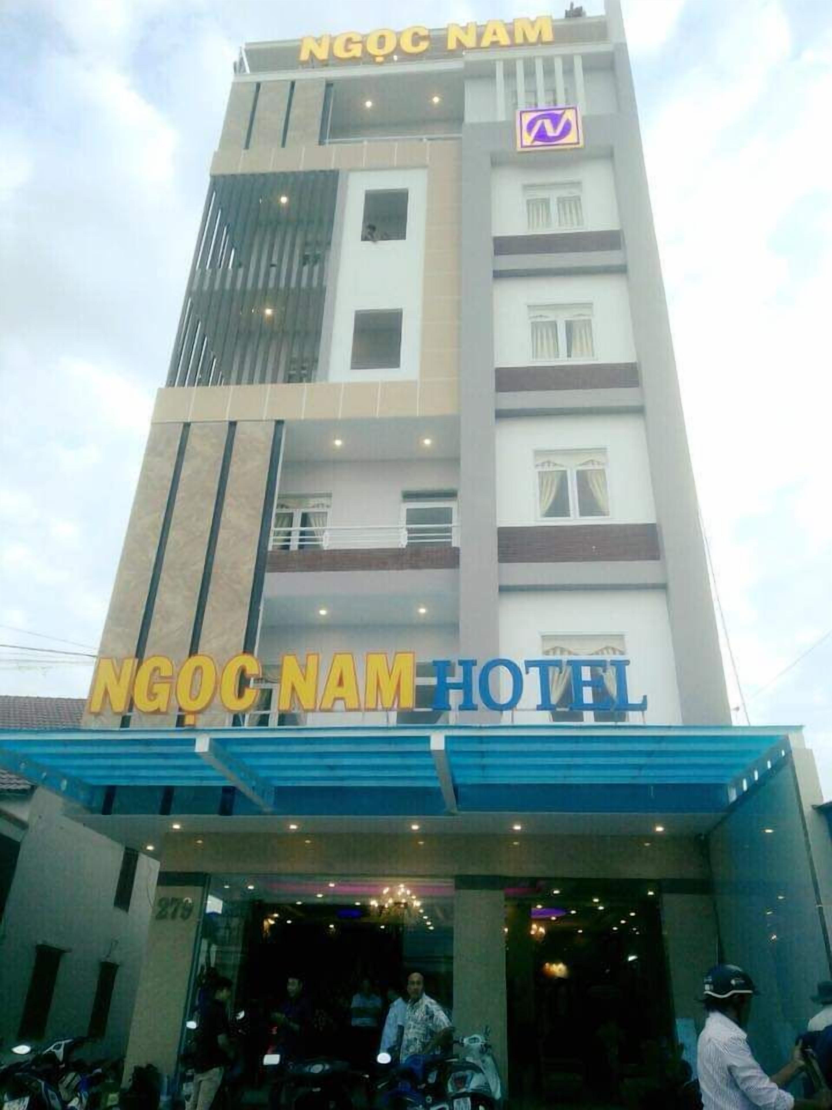 A hotel building with the name 'NGOC NAM HOTEL' prominently displayed on the facade.