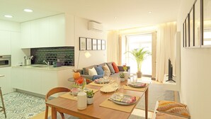 A modern apartment with a kitchen, dining area, and living room.