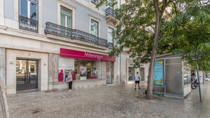 A cobblestone street with a building labeled 'Millennium BCP'.
