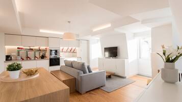 A modern apartment with a kitchen, living room, and dining area.