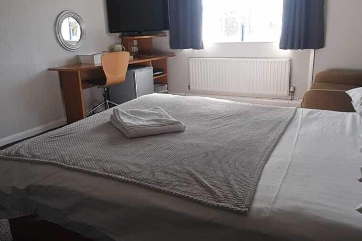 Desk, iron/ironing board, bed sheets