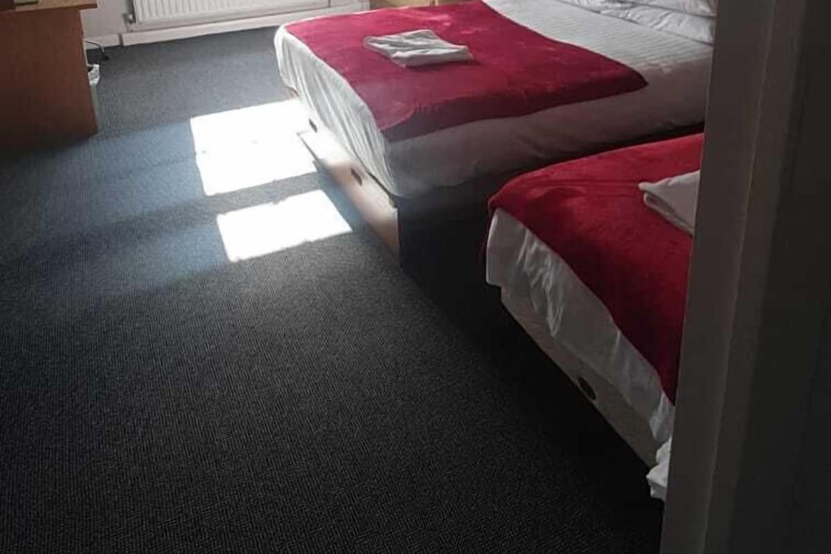 Desk, iron/ironing board, bed sheets