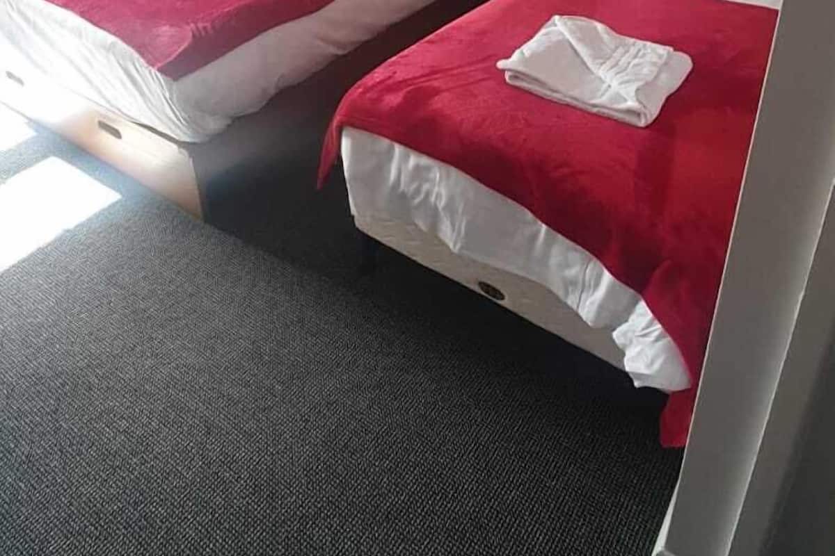 Desk, iron/ironing board, bed sheets