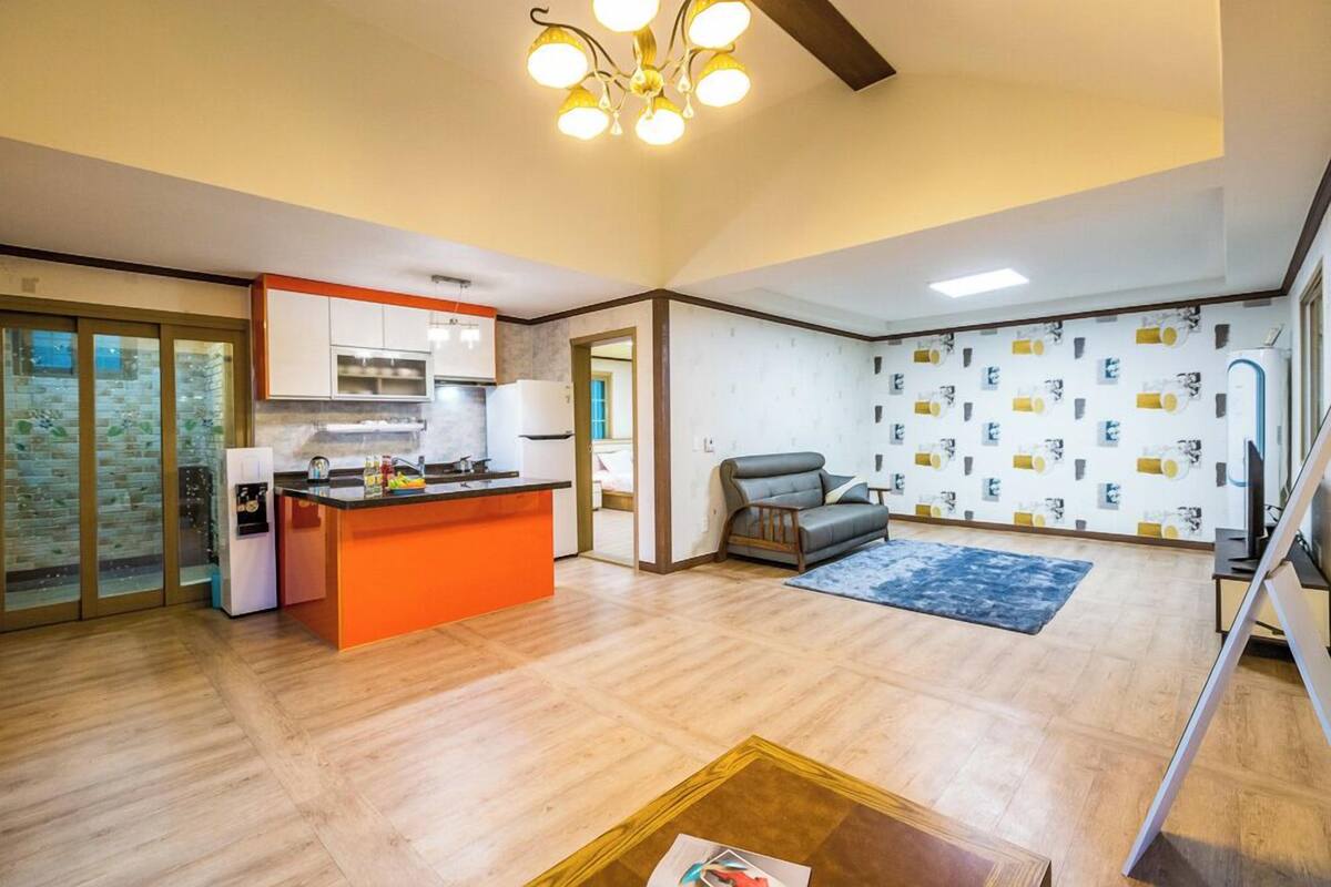 A modern living space with a kitchen, a dining area, and a seating area.