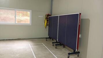 A room with a large window, a door, and a wall-mounted cabinet.