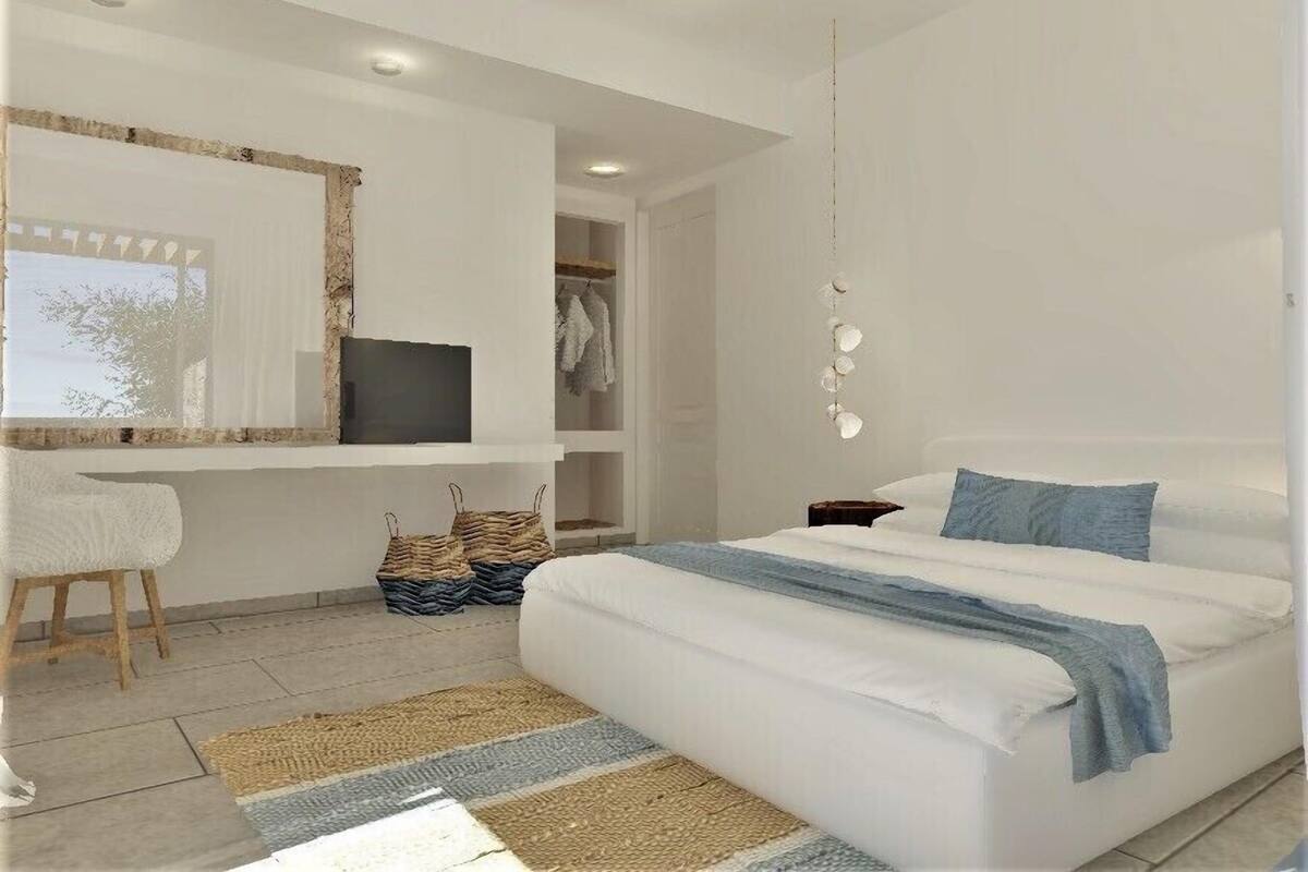 A modern bedroom with a bed, a desk, and a wardrobe.
