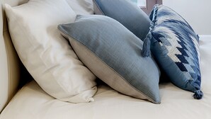 A bedroom with a large window, a bed with white and grey pillows, and a white pendant light. - Hostal Altea House (Altea)