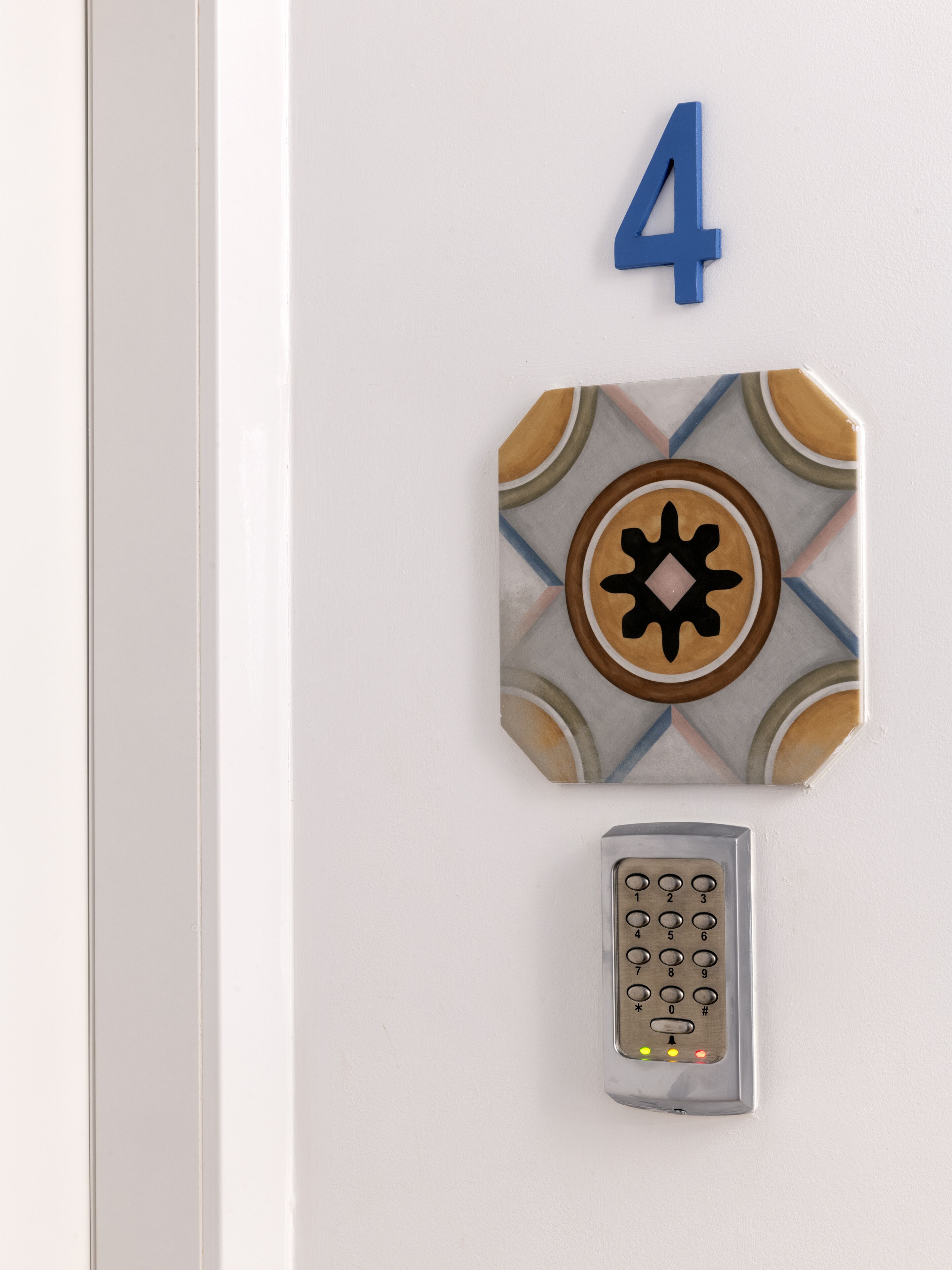 A door with a number 4 sign above a keypad lock.