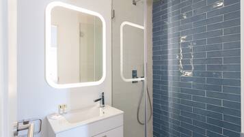 Shower, hair dryer, towels, shampoo