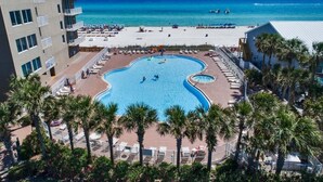 A resort with a large pool, a beach, and a view of the ocean. - Master on Gulf -Free round of Golf, Beach Chairs, & Activities Every Day! (Panama City Beach)