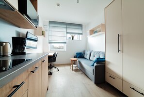 Deluxe Studio Suite | Living area | TV - RentNice-Starter 3 (Wroclaw)