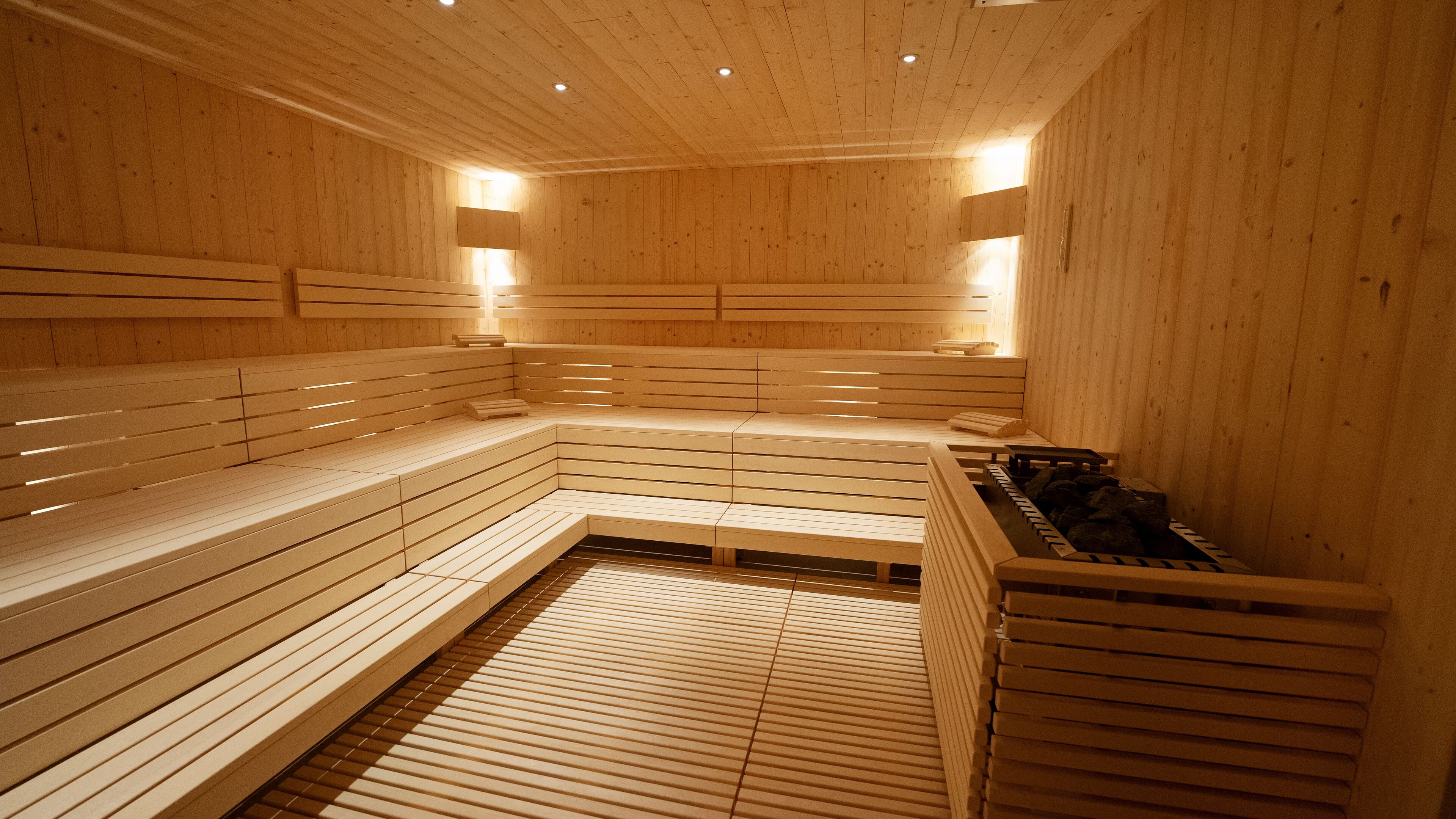 A wooden sauna with benches and a bench seat.