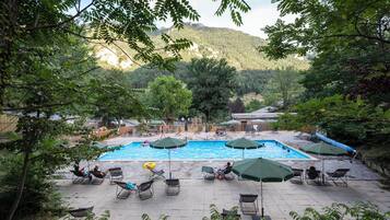 Seasonal outdoor pool, open 9:00 AM to 6:00 PM, pool umbrellas