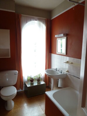 Bathtub, towels, soap, toilet paper