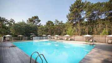 Seasonal outdoor pool, open 9:00 AM to 6:00 PM, pool umbrellas