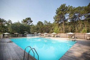 Seasonal outdoor pool, open 9:00 AM to 6:00 PM, pool umbrellas