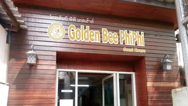 The exterior of Golden Bee Phi Phi Guest House with a wooden facade and a glass entrance. - Golden Bee PhiPhi Hostel (Ko Phi Phi)