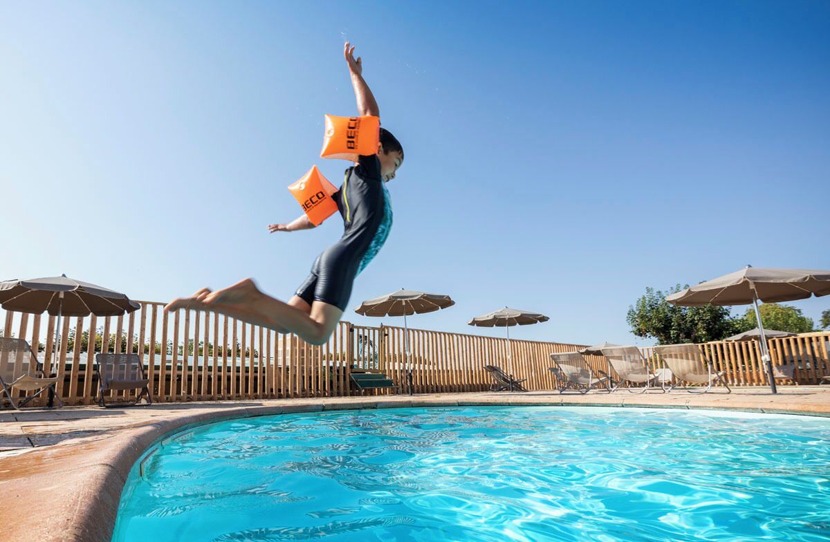 Seasonal outdoor pool, open 9:00 AM to 6:00 PM, pool umbrellas