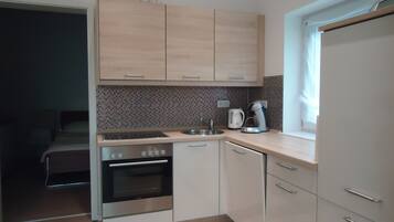 Fridge, stovetop, dishwasher, coffee/tea maker