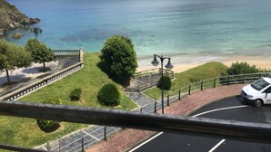 A parking area with a view of the sea and a hilly landscape. - Apartment on the ocean and the beach. . (santa marta de ortigueira)