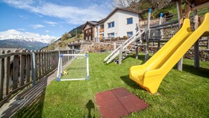 A playground with a yellow slide, a soccer goal, and a red mat. - Rustic Apartment Vermoi on Mountain Farm with Terrace (Kastelbell-Tschars)