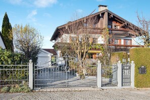 A large, multi-story building with a traditional architectural style, featuring a prominent balcony on the upper floor.