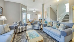 A spacious living room with striped armchairs, a light blue sofa, and a patterned rug. - Dreamscaper - Five Bedroom, Four 1/2 Bath Home with private pool (Surfside Beach)