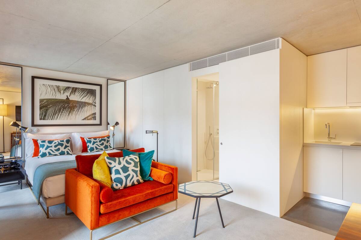 A modern living room with a sofa, a coffee table, and a framed picture on the wall.