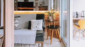 A modern living room with a sofa, a coffee table, and a TV.
