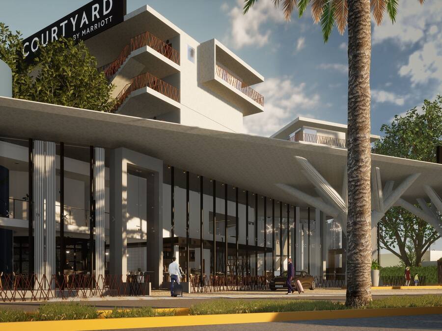 Ein modernes Gebäude mit mehreren Balkonen und einem Schild mit der Aufschrift "COURTYARD BY MARRIOTT".