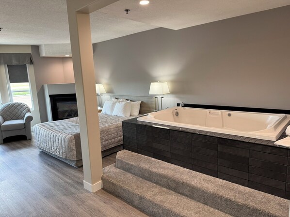 Habitación Deluxe, 1 cama Queen size, cocina (Spa Tub) | Escritorio, espacio para trabajar con laptop y insonorización