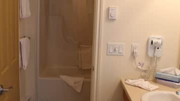 A bathroom with a shower, a sink, and a toilet.
