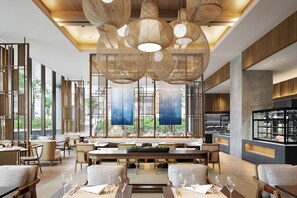 A modern restaurant with high ceilings, large windows, and a central dining area with tables and chairs. - JW Marriott Hotel Nara (Nara)