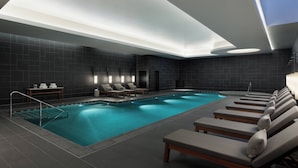 A modern indoor swimming pool with lounge chairs and a sunbed area. - JW Marriott Hotel Nara (Nara)