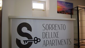 A sign for Sorrento Deluxe Apartments with a large 'S' and a key symbol. - in the real heart of Sorrento (Sorrento)