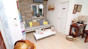 Una sala de estar con un sofá, una mesa de centro y objetos decorativos.