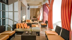 A modern lounge area with sofas and armchairs, a coffee table, and a fireplace. - Mayan Palace In Acapulco inside Vidanta Resort Luxury in your services (Acapulco)