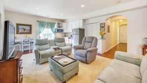 A spacious living room with a sofa, armchairs, a coffee table, and a TV. - A Little Luxury near the AFA and Ford Amphitheater (Colorado Springs)