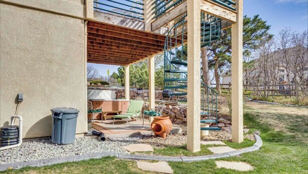 A covered outdoor patio area with a pergola, a barbecue grill, and a seating area with a table and chairs. - A Little Luxury near the AFA and Ford Amphitheater (Colorado Springs)